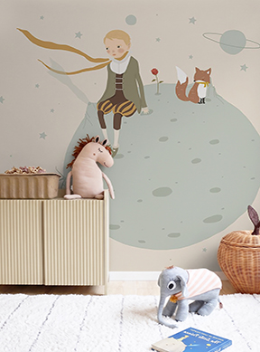 Custom made-to-measure nursery mural wallpaper called Le Petit Prince, featuring the Little Prince and the fox on a planet in soft sage green, beige and gold tones, installed in a neutral boho nursery