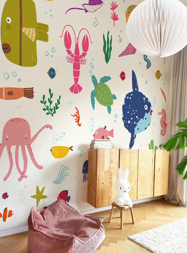 Colorful underwater-themed wallpaper with smiling sea creatures like fish, crabs, and octopuses, designed for children’s rooms.